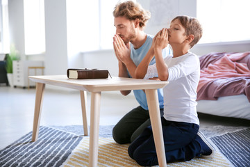 Wall Mural - Father with son praying at home