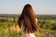 © Valua Vitaly - Young girl sits with his back to the camera and looks at nature