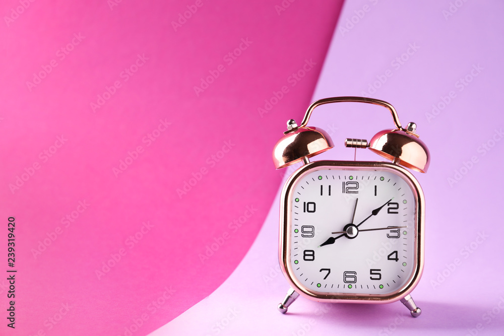 Alarm clock on color background