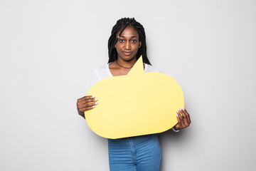 Wall Mural - Young african woman screaming in blank speech bubble isolated on black background