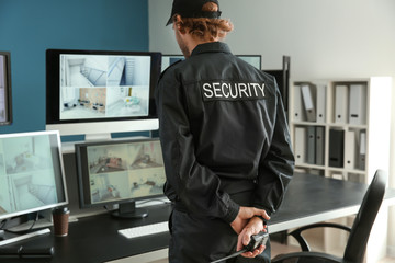 Sticker - Security guard monitoring modern CCTV cameras in surveillance room