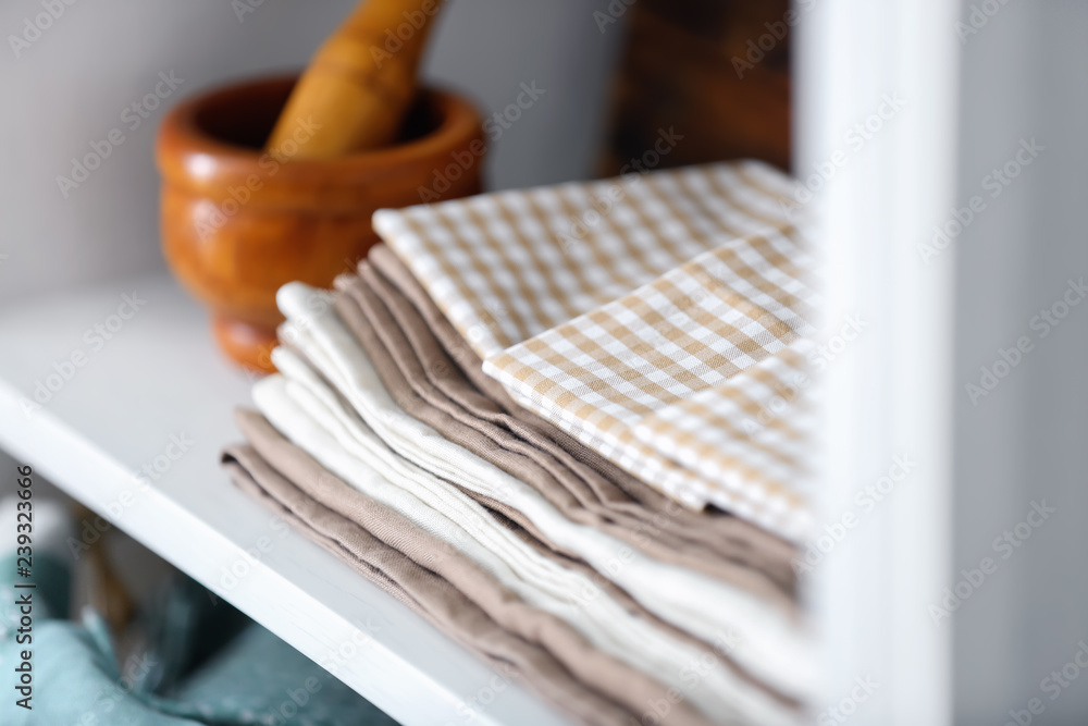 Clean kitchen towels on shelf