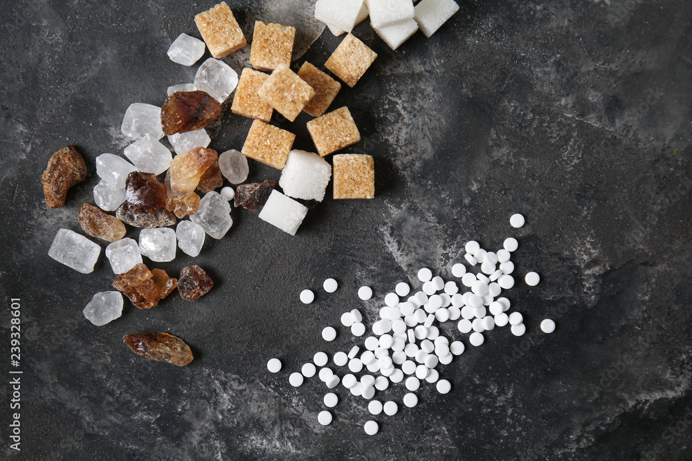 Different kinds of sugar on grey table