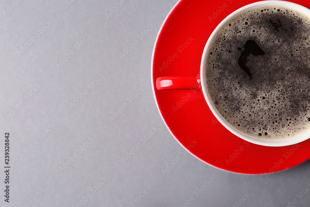 Cup of tasty aromatic coffee on grey background