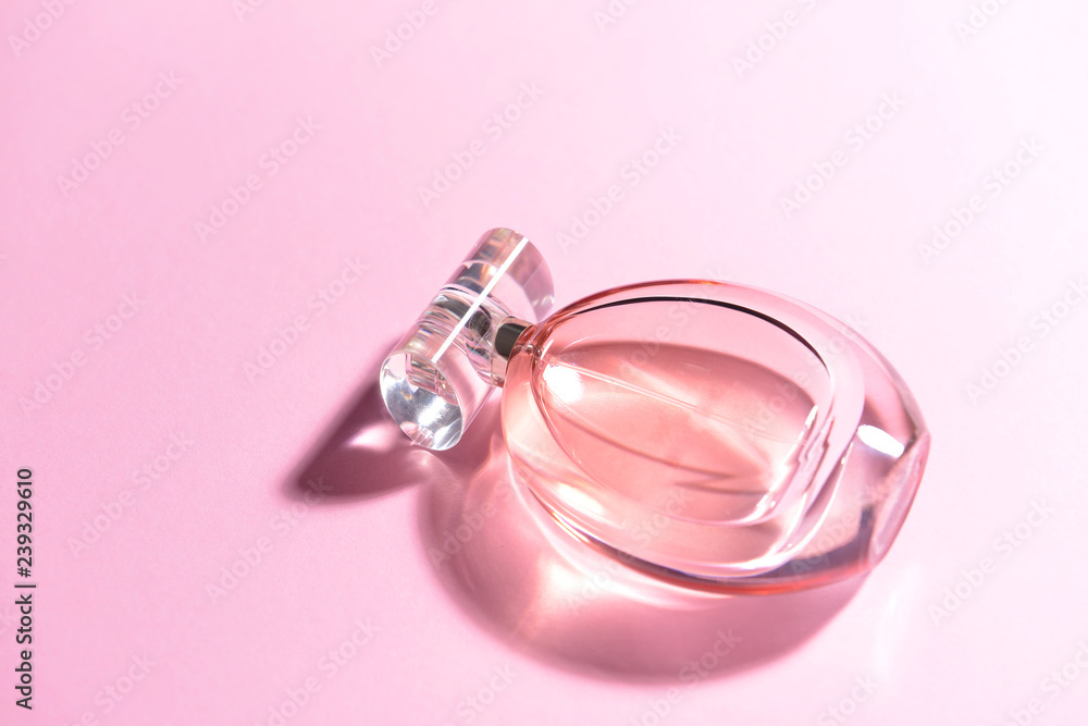 Bottle of perfume on color background