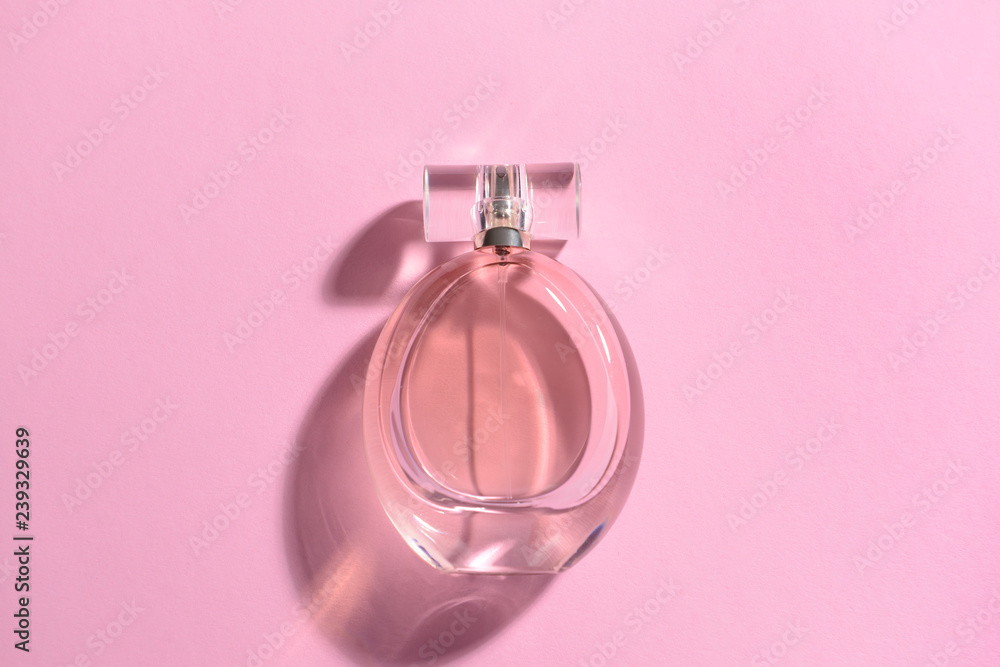 Bottle of perfume on color background