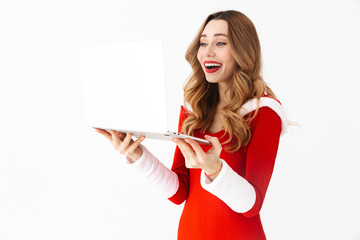 Sticker - Happy excited woman in christmas costume using tablet computer.