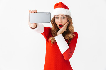 Wall Mural - Emotional woman in christmas costume take a selfie by mobile phone.