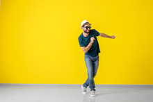 Handsome Young Man Dancing Near Color Wall