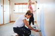 © Monkey Business - Two Women Decorating Room In New Home Painting Wall