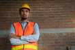 © somchaikhun - Asian or Arub man is architect or civil engineer stand on working site with safety helmet .