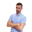 © Elena Kharichkina - Casually handsome. Confident young handsome man in jeans shirt keeping arms crossed and smiling while standing against white background