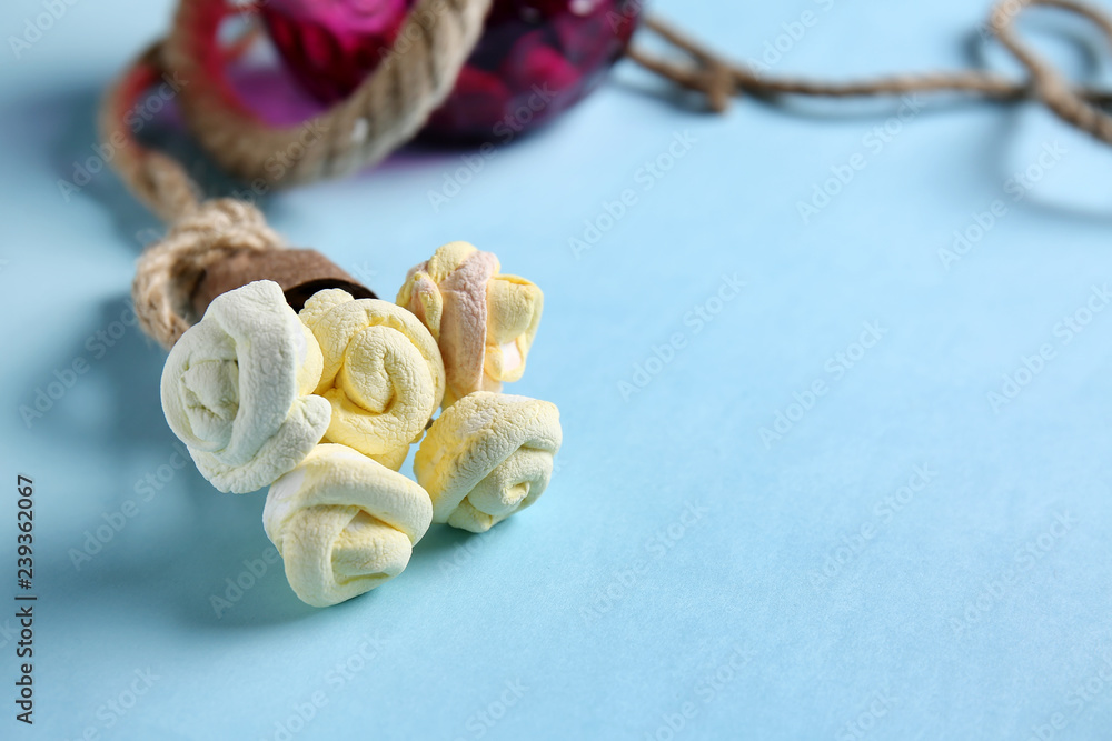 Creative bouquet made of tasty marshmallow on color background