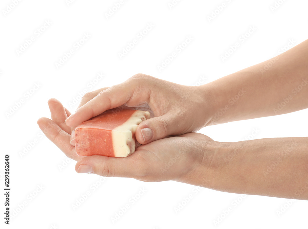 Female hands with soap bar on white background