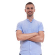 © Elena Kharichkina - Casually handsome. Confident young handsome man in jeans shirt keeping arms crossed and smiling while standing against white background