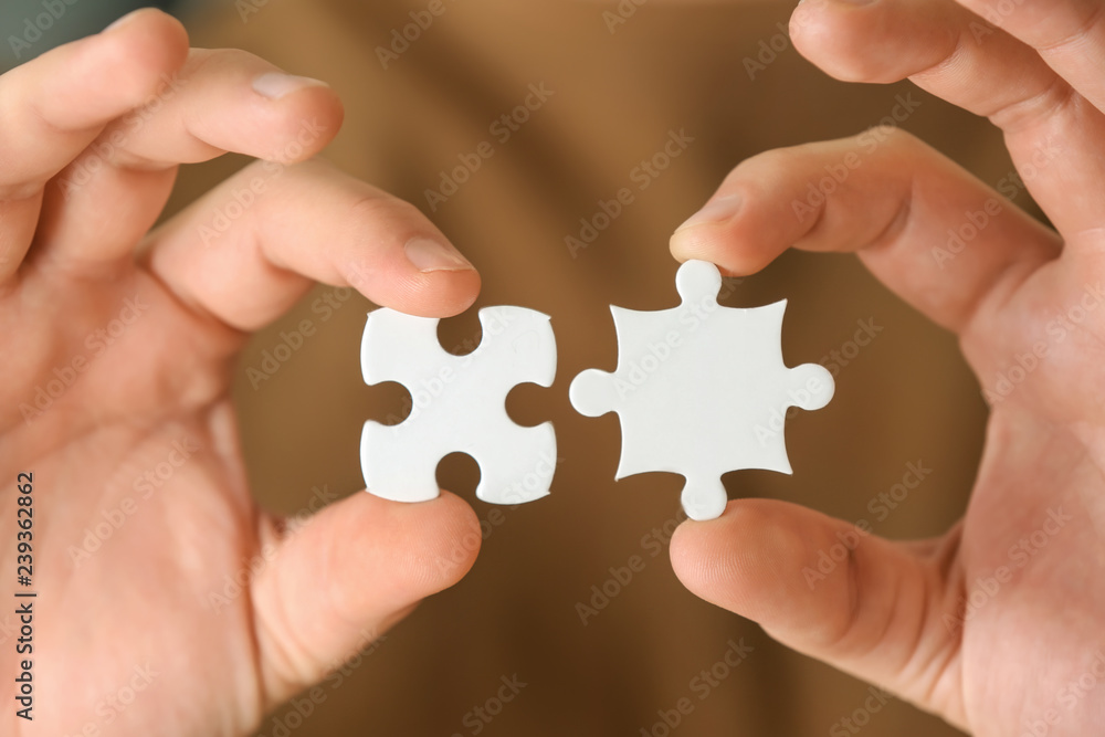 Man holding pieces of puzzle, closeup