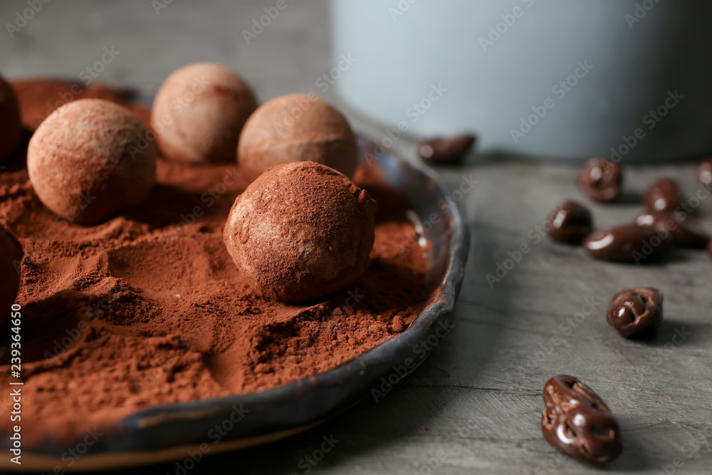 Sweet truffles with cacao powder on plate