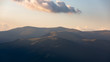 © Andrei - Beautiful sunset rays falling on top of a valley in Buila Vanturarita mountains, Romania