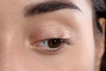 Poster - Young woman with beautiful natural eyelashes, closeup view