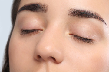 Poster - Young woman with beautiful natural eyelashes, closeup view