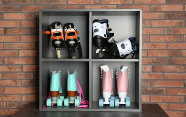 Wall Mural - pairs of roller skates on shelves near brick wall