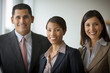 © Erickson Stock - Portrait of three smiling business colleagues.