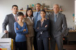 © Erickson Stock - Portrait of six confident business colleagues standing inside their office.