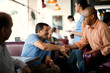 © Erickson Stock - Smiling friends meeting for coffee at a local diner.