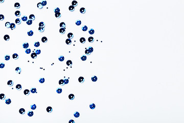 Round blue sequins on white background