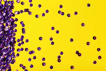 Round purple sequins on yellow background