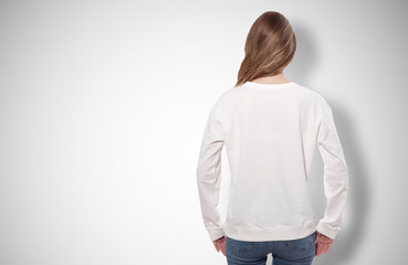 Wall Mural - young woman in white sweatshirt, white hoodies. grey background