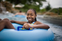 Portrait Of Smiling Girl With Swim Ring In Swimming Pool