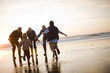 © Erickson Stock - Two boys running to embrace their family on a beach