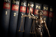 Statue of justice on books background