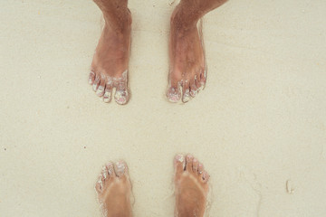 Two people on the beach. Man and woman stand on the sand 