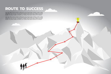 Silhouette team businessman plan to get champion trophy on top of mountain. Concept of teamwork and planning path in business