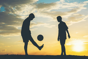 Wall Mural - Silhouette of children play soccer football