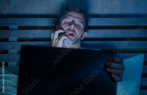 man alone in bed playing cybersex using laptop computer watching porn sex  movie late at night with lascivious pervert face expression in internet  pornographic sexual content Stock Photo | Adobe Stock