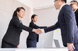 © gballgiggs - Business asian team people shaking hands after finishing up meeting in conference room