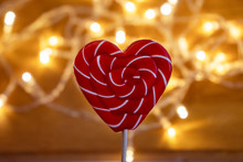 Candy Heart With Red White Stripes On The Garland Background. Valentines Day
