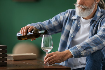 Canvas Print - Senior man drinking wine at home