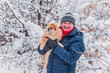 © T.Den_Team - Senior man dog lover with his red pekingese pet on a walk at snowy park. Concept love and care of animals. Good people caring for pets