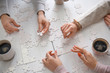 © Pixel-Shot - People doing puzzle at table