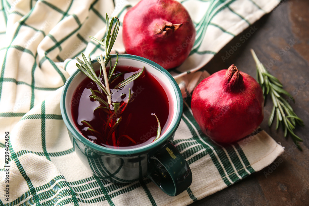 Cup of tasty pomegranate juice on table
