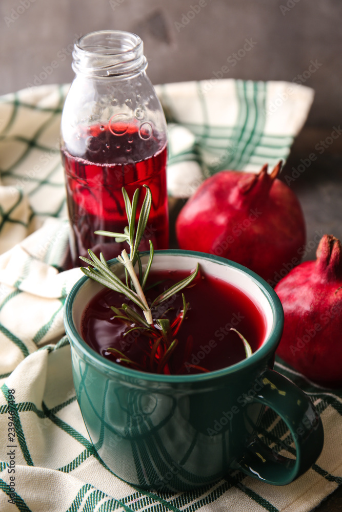Cup of tasty pomegranate juice on table