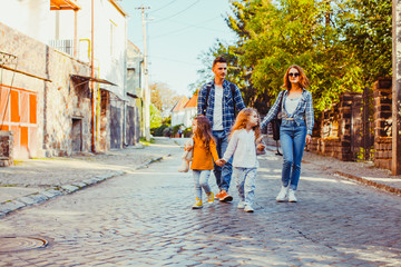 Two girls walking with their mother and father