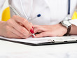© megaflopp - Female doctor arm hold silver pen and pad