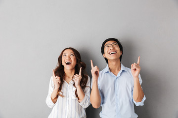 Wall Mural - Cheerful asian business couple standing