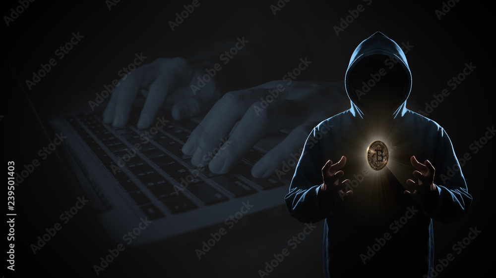 Golden Bitcoin floating above of hacker's hand in dark on hacker hacking with computer laptop background with copy space. Finance, business, e-commerce or cyber crime concept