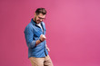 © opolja - Portrait of a satisfied young man celebrating success isolated over pink background.
